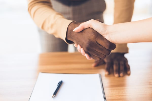 Two business professionals shaking hands - Pitchly's tombstone builder